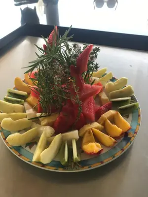 a plate of fruit and vegetables on a table at VILLA ALBA ROSULA in Ajaccio