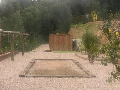 a garden with a wooden building in the background at VILLA ALBA ROSULA in Ajaccio