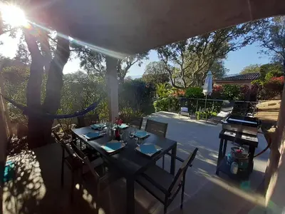 a table and chairs sitting on a patio at Villa Pinarello climatisée avec piscine chauffée in Sainte-Lucie de Porto-Vecchio