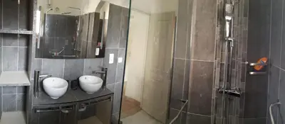 a bathroom with two white vases on a counter at Villa Pinarello climatisée avec piscine chauffée in Sainte-Lucie de Porto-Vecchio