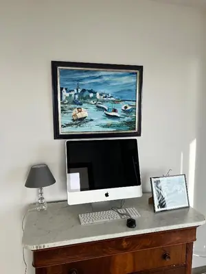 a computer on a desk with a painting on the wall at Appartement 140M2 villa cargèse in Cargèse
