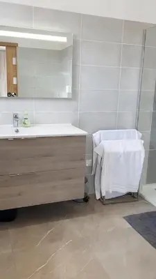 a bathroom with a sink and a mirror at Appartement 140M2 villa cargèse in Cargèse