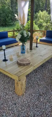 a wooden table with a vase on top of it at Domaine Authentique de Rose in Porto-Vecchio