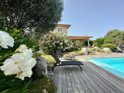 a patio with a table and chairs on a patio at villa Filao Sainte Lucie de Porto vecchio in Sainte-Lucie de Porto-Vecchio