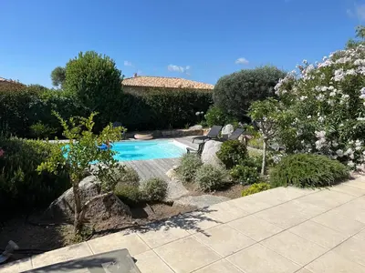 a patio with chairs and a swimming pool at villa Filao Sainte Lucie de Porto vecchio in Sainte-Lucie de Porto-Vecchio