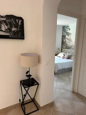 a bedroom with a bed and a lamp in a room at villa Filao Sainte Lucie de Porto vecchio in Sainte-Lucie de Porto-Vecchio