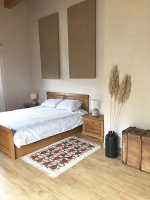 a bedroom with a bed and a rug on the floor at Villa familiale entre mer et montagne Corse in Soccia