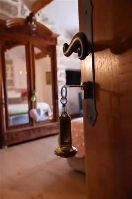 a close up of a door with a bell on it at Auberge U n'Antru Versu in San-Gavino-di-Carbini
