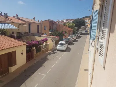 a white car parked on the side of a street at Charmant 2 pièces en plein coeur du village in Cargèse
