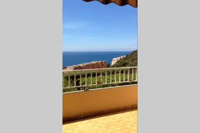 a view of the ocean from the balcony of a house at T2 Sanguinaires calme et cosy, entre mer et maquis in Ajaccio