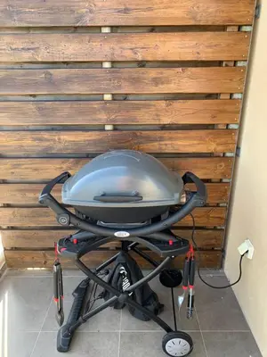 a gray stroller in front of a wooden wall at Appartement F2 Porto Vecchio vue sur les salines in Porto-Vecchio