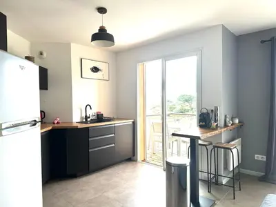 a kitchen with a refrigerator and a counter top at Appartement F2 Porto Vecchio vue sur les salines in Porto-Vecchio