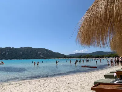 a group of people in the water on a beach at Appartement F2 Porto Vecchio vue sur les salines in Porto-Vecchio