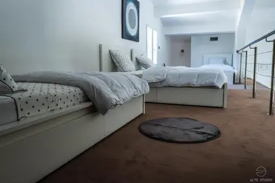 a bedroom with two beds and a rug at Casa Lagone - Villa Luxe avec Piscine et Superbe Vue in Cargèse