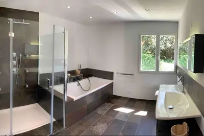 a bathroom with a tub and a shower and a sink at Casa Lagone - Villa Luxe avec Piscine et Superbe Vue in Cargèse