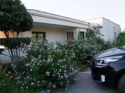 a bunch of flowers in front of a house at VUE MAGNIFIQUE SUR BAIE AJACCIO in Porticcio