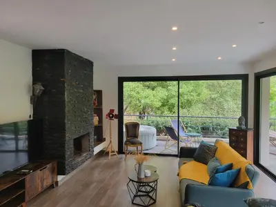 a living room with a yellow couch and a fireplace at Casa San-Ghjuvà in Feliceto