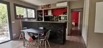 a kitchen with a counter and a table and chairs at Casa San-Ghjuvà in Feliceto