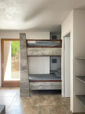 a bedroom with bunk beds in a room with a window at A Casa di Santa Giulia in Porto-Vecchio