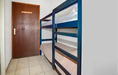 a bunk bed in a room with a door at 1 Bedroom Amazing Apartment In Prunete in Prunete