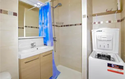 a bathroom with a sink and a washing machine at 1 Bedroom Amazing Apartment In Prunete in Prunete