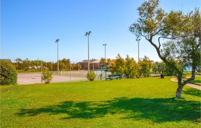 a park with a tree and a bench in the grass at 1 Bedroom Amazing Apartment In Prunete in Prunete