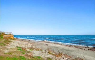 an empty beach with the ocean in the background at 1 Bedroom Amazing Apartment In Prunete in Prunete