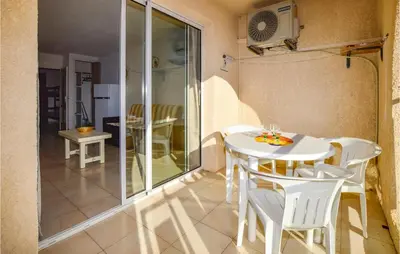 a small dining room with a white table and chairs at 1 Bedroom Amazing Apartment In Prunete in Prunete
