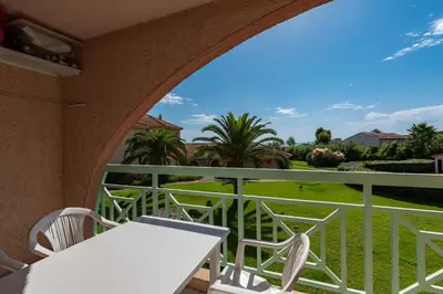 a balcony with a table and chairs and a view at Arinella in San-Nicolao
