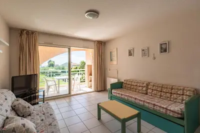 a living room with a couch and a tv at Arinella in San-Nicolao