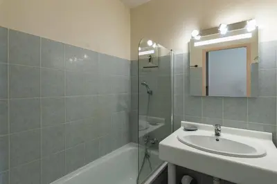 a bathroom with a sink and a shower and a mirror at Arinella in San-Nicolao