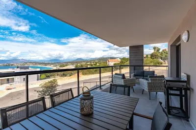 a view from the balcony of a house with a table and chairs at Les Rivages De Stagnola - Vue Mer et Plages à Pied in Pietrosella