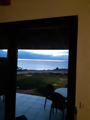 a room with a view of the ocean through a window at Residences La Tonnara in Bonifacio