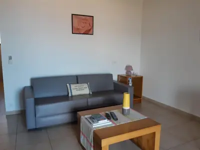 a living room with a couch and a coffee table at Residences La Tonnara in Bonifacio