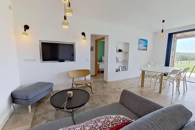 a living room with a couch and a table at Bergeries de l'Argiale - ARGHJALE - hôtel in Figari