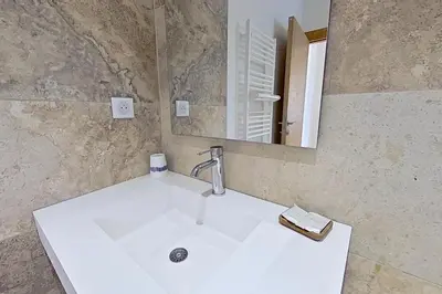 a white sink in a bathroom with a mirror at Bergeries de l'Argiale - ARGHJALE - hôtel in Figari
