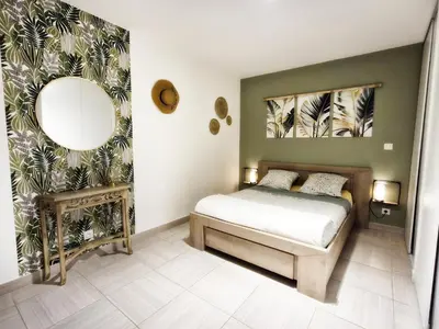 a bedroom with a bed and a mirror at Isula Bella in Prunelli-di-Fiumorbo