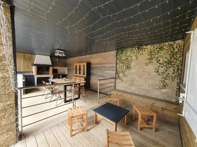 a room with chairs and tables and a wall with ivy at Isula Bella in Prunelli-di-Fiumorbo