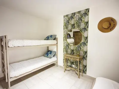 a bedroom with a bed and a blue wall at Isula Bella in Prunelli-di-Fiumorbo