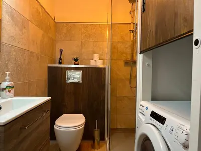 a bathroom with a toilet and a sink and a washing machine at Marina'home in Ajaccio