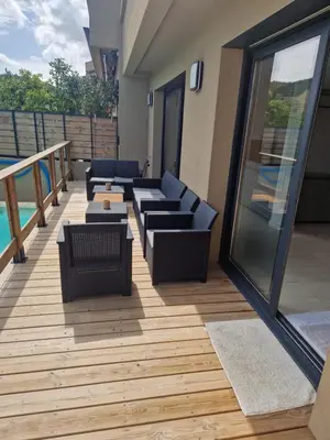 a patio with a couch and chairs on a deck at Villa di Favona 4 chambres piscine privée in Conca