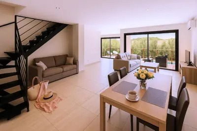 a living room with a table and a dining room at Villa di Favona 4 chambres piscine privée in Conca