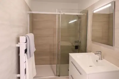 a bathroom with a shower and a sink and a mirror at Villa di Favona 4 chambres piscine privée in Conca