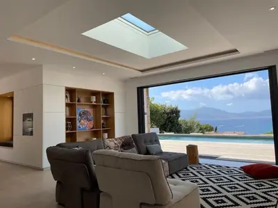 a living room with a couch and a large window at Villa Alandra in Pietrosella