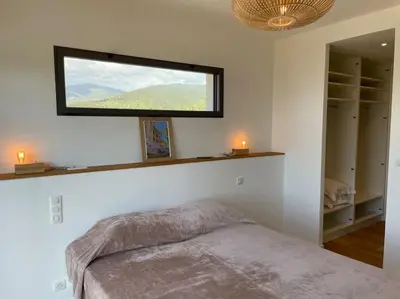 a bedroom with a bed with a window above it at Villa Alandra in Pietrosella