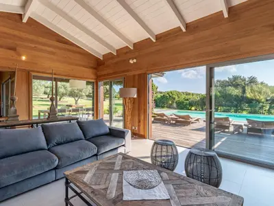 a living room with a couch and a table at Holiday Home Villa Lavezzi by Interhome in Bonifacio