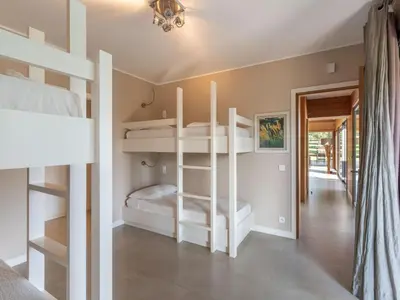 a bedroom with two bunk beds and a hallway at Holiday Home Villa Lavezzi by Interhome in Bonifacio