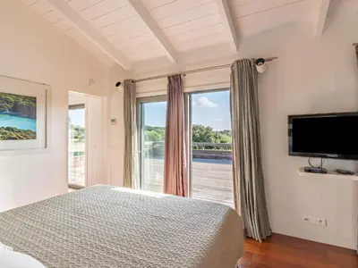 a bedroom with a bed and a large window at Holiday Home Villa Lavezzi by Interhome in Bonifacio