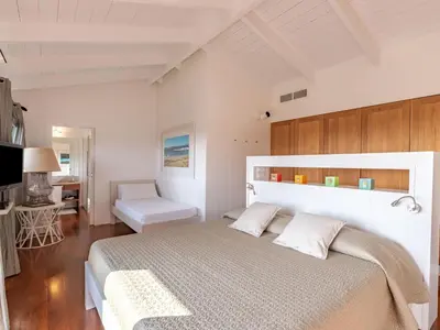 a bedroom with a large white bed in a room at Holiday Home Villa Lavezzi by Interhome in Bonifacio