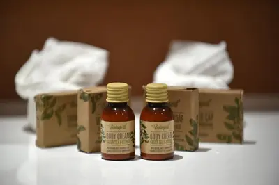 two bottles of honey on a table next to boxes at Hôtel Alivi Di Santa Giulia in Porto-Vecchio
